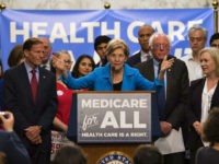 US Senator Elizabeth Warren (C), Democrat from Massachusetts, speaks with US Senator Bernie Sanders (2nd R), Independent from Vermont, as they discusses Medicare for All legislation on Capitol Hill in Washington, DC, on September 13, 2017. The former US presidential hopeful introduced a plan for government-sponsored universal health care, a …