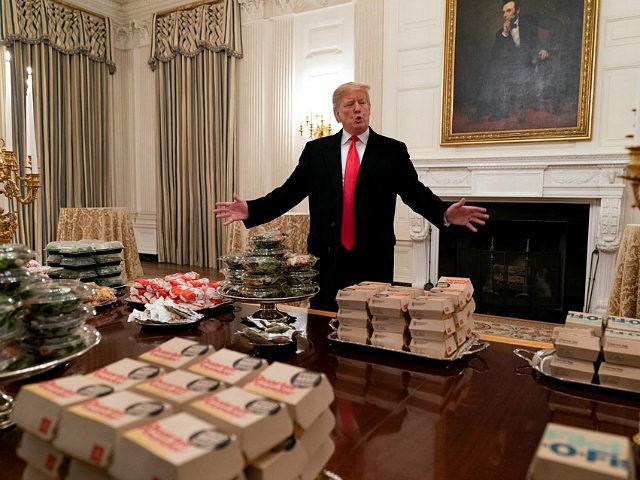 WASHINGTON, DC - JANUARY 14: (AFP OUT) U.S President Donald Trump presents fast food to be