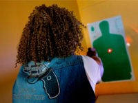 Javondlynn Dunagan of JMD Defense and Investigations demonstrates the laser on a Shot Indicating Resetting Trigger (SIRT) Training Pistol in her training classroom in Chicago, Illinois, July 19, 2017. (Photo by JIM YOUNG / AFP) / With AFP Story by Nova SAFO: A gun club for Chicago women concerned about …