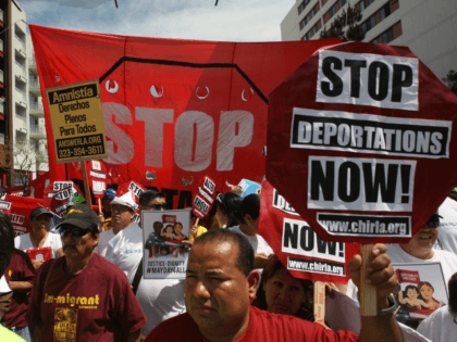 LOS ANGELES, CA - MAY 1: Marchers rally under the Chinatown Gateway before marching to the
