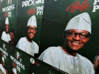 A picture taken January 16, 2019, shows a wall plastered with campaign posters of Nigeria's incumbent president and candidate from the ruling All Progressives Congress (APC) party, Muhammadu Buhari, ahead of the country's general elections next February. (Photo by PIUS UTOMI EKPEI / AFP) (Photo credit should read PIUS UTOMI …