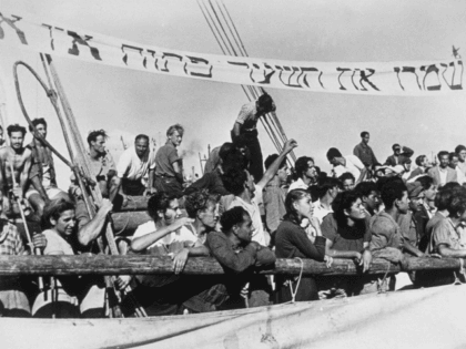 17th June 1946: The 'Haviva Reik', a small ship containing some 450 Jewish refugees, on arrival at Haifa on 8th June, after a dangerous journey across the Mediterranean. The banner in hebrew reads 'Keep the gates open, we are not the last.' (Photo by Keystone/Getty Images)