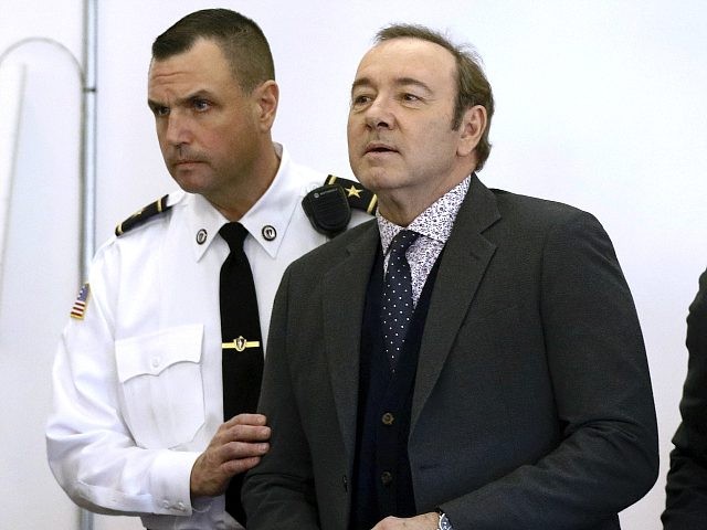 Actor Kevin Spacey enters the courtroom at district court for arraignment on a charge of i