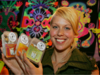 Full Moon store owner Chloe Collette poses with some of magic mushrooms she has for sale in Amsterdam, Netherlands, Thursday Aug. 2, 2007. It's high season for tourists, but for many the emphasis is on the word high. Thousands come specifically to smoke marijuana without fear of getting into trouble …
