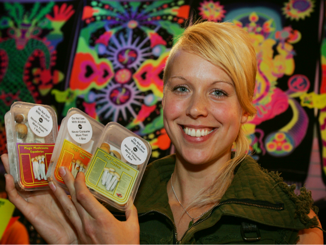 Full Moon store owner Chloe Collette poses with some of magic mushrooms she has for sale i