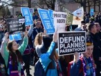 march-for-life-jan-2018-anti-abortion-signs-getty Anti-abortion activists from around the US gather in Washington, DC January 19, 2018 for the annual 'March for Life.' / AFP PHOTO / Eva HAMBACH (Photo credit should read EVA HAMBACH/AFP/Getty Images)