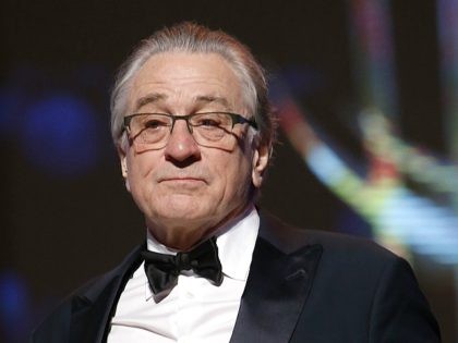 Robert De Niro poses for photographers after receiving a tribute to his contribution to ac