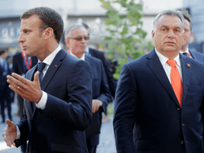 Hungary's Prime Minister Viktor Orban (R) and France's President Emmanuel Macron arrive at