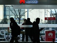 Pedestrians walk past a Huawei store in Beijing on December 28, 2018. - Chinese telecoms giant Huawei expects to see a 21 percent rise in revenue for 2018, its chairman said on December 27, despite a year of 'unfair treatment' which saw its products banned in several countries over security …