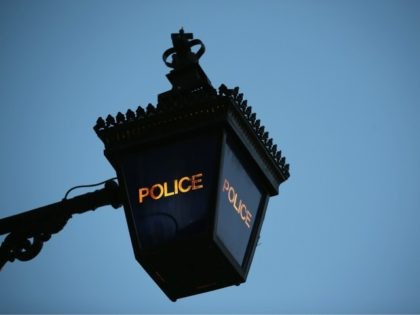 LONDON, ENGLAND - FEBRUARY 15: A Police Lantern glows at twilight outside Kennington Polic