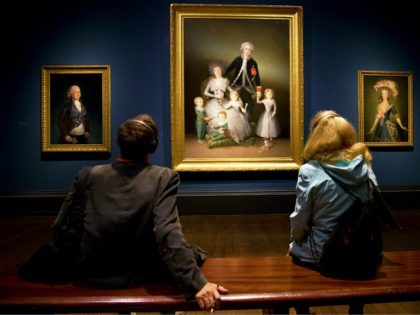 Visitors look at paintings 'The Duke of Osuna around 1795' (L), 'The Duke and Duchess of Osuna and their Children 1788' (C), and 'The Countess-Duchess of Benavente 1785 by Spanish artist Francisco de Goya during a press preview of 'Goya, The Portraits' at the National Gallery in London on October …