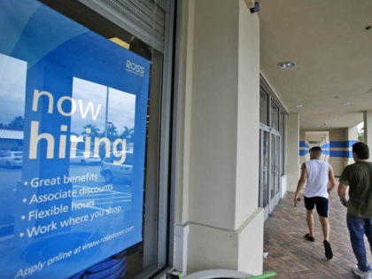FILE - In this May 16, 2014 file photo, shoppers walk past a now hiring sign at a Ross store in North Miami Beach, Fla. The Labor Department releases weekly jobless claims on Thursday, Sept. 10, 2015. (AP Photo/Wilfredo Lee, File) unemployment