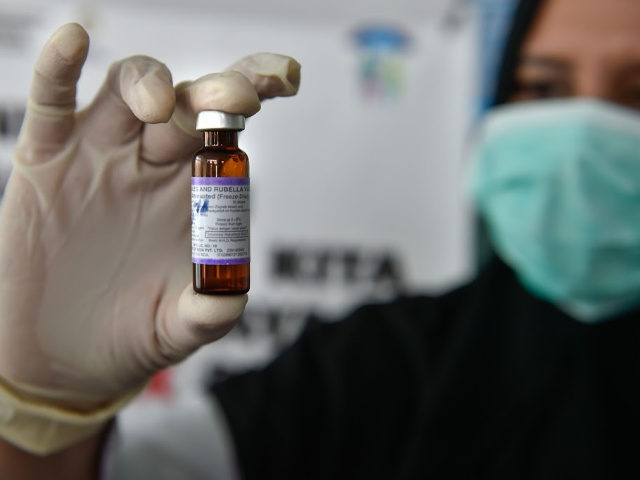 A medical worker holds a measles-rubella (MR) vaccine at a health station in Banda Aceh in