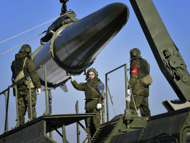 Russian soldiers load an Iskander-M missile launcher during a military exercise at a firin