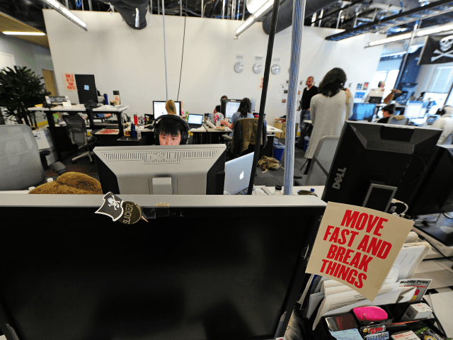 Employees work at their computers at the Facebook main campus in Menlo Park, California, M