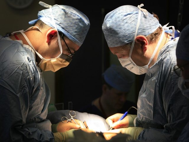 surgeons operating on a patient