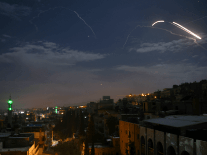 A picture taken early on January 21, 2019 shows Syrian air defence batteries responding to what the Syrian state media said were Israeli missiles targeting Damascus. - Israel struck what it said were Iranian targets in Syria today in response to rocket fire it blamed on Iran, sparking concerns of …