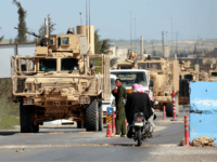 A picture taken on April 3, 2018 shows vehicles of US-backed coalition forces driving in the northern Syrian town of Manbij. - On the outskirts of Syria's Manbij, Kurdish-led fighters have dug trenches and US-led coalition soldiers patrol from land and sky after Turkey threatened to overrun the northern city. …