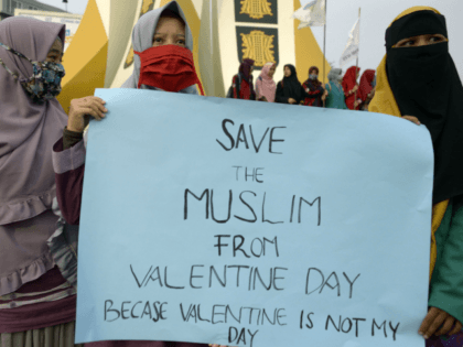 Indonesian Muslim students hold a protest against Valentine's Day in Banda Aceh on February 14, 2018. Valentine's Day was banned in some Indonesian cities on February 14 as police rounded up amorous couples, giving the official kiss-off to a tradition which critics say doesn't deserve any love in the Muslim-majority …