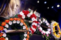Flowers are laid during a memorial service for late Israeli writer Amos Oz on December 31, 2018 in Tel Aviv