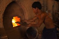 A Cambodian labourer stokes a kiln at a brick factory on the outskirts of Phnom Penh