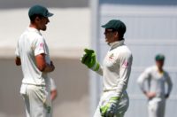 Australia's captain Tim Paine (R) could have been forgiven for wanting to get out of the room as fast as possible after 167 overs behind the stumps against India
