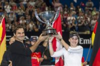 Roger Federer and his mixed doubles partner Belinda Bencic of Switzerland with the Hopman Cup after defeating runners-up Alexander Zverev and Angelique Kerber of Germany