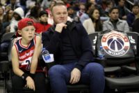 DC United striker and former England captain Wayne Rooney, shown last month with his son watching an NBA game in Washington, was arrested for public intoxication last month