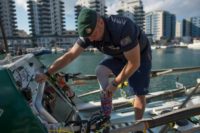 Former British Royal Marine, Lee Spencer, known as 'The Rowing Marine', puts his prosthetic leg on his limb before setting off from Gibraltar to begin his solo rowing journey across the Atlantic to South-America