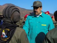 Venezuela's Nicolas Maduro (C) has sought to maintain the loyalty of the military Venezuela bars self-declared president Guaido from leaving country