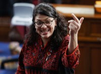 Trump Impeachment Rashida Tlaib In this Thursday, Jan. 3, 2019 photo, then Rep. elect Rashida Tlaib of Michigan, is shown on the house floor before being sworn into the 116th Congress at the U.S. Capitol in Washington. Tlaib exclaimed at an event late Thursday that Democrats were going to “impeach the mother .” According to video and comments on Twitter, she apparently made the comments during a party hosted by the liberal activist group MoveOn. (AP Photo/Carolyn Kaster) The Associated Press