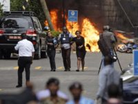 APTOPIX Kenya Attack Security forces help civilians flee the scene as cars burn behind, at a hotel complex in Nairobi, Kenya Tuesday, Jan. 15, 2019. Terrorists attacked an upscale hotel complex in Kenya's capital Tuesday, sending people fleeing in panic as explosions and heavy gunfire reverberated through the neighborhood. (AP Photo/Ben Curtis) The Associated Press