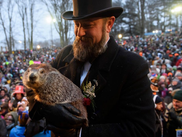 Handler AJ Dereume holds Punxsutawney Phil after he did not see his shadow predicting an e