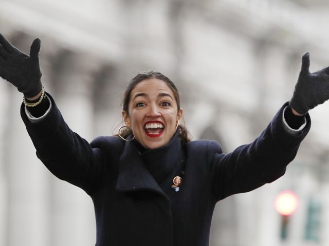 U.S. Rep. Alexandria Ocasio-Cortez, (D-New York) waves to the crowd as she steps onto the