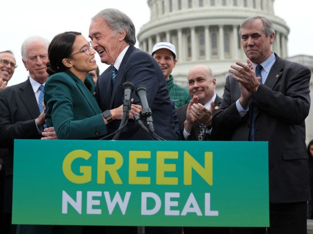 U.S. Rep. Alexandria Ocasio-Cortez (D-NY) (L) and Sen. Ed Markey (D-MA) (R) hug each other