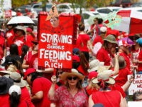 Arizona-teachers-strike-redfored-ap Thousands participate in a protest at the Arizona Capitol for higher teacher pay and school funding on the first day of a state-wide teachers strike Thursday, April 26, 2018, in Phoenix. A sea of teachers clad in red shirts and holding "Money for Schools" signs reached the Arizona Capitol to …