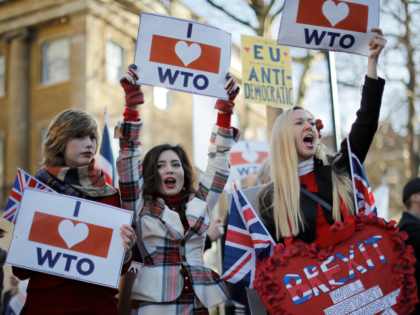 Pro-Brexit activists hold placards and wave flags as they demonstrate opposite Downing Street in central London on February 14, 2019. - Prime Minister Theresa May risks another humiliating Brexit defeat at the hands of her own eurosceptic MPs on Thursday, with just weeks to go until Britain officially leaves the …