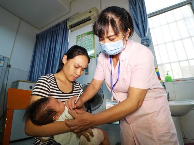 A child receives a vaccination shot at a hospital in Rongan in China's southern Guangxi re