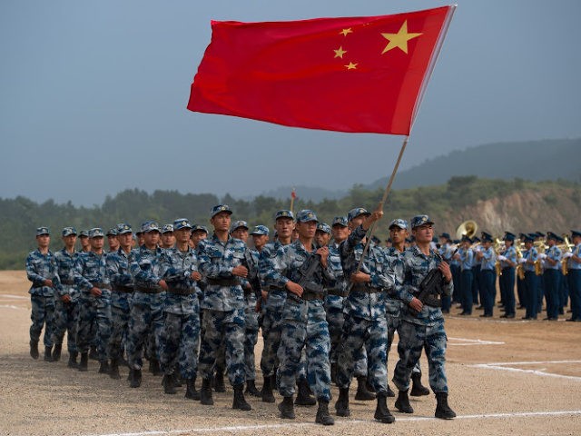 Chinese People's Liberation Army Air Force (PLAAF) personnel marching with their national flag during the opening ceremony of the International Army Games 2017 in Guangshui in China's central Hubei province.