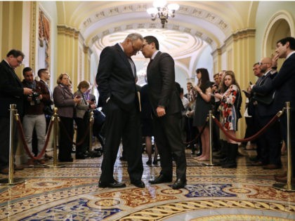 Senate Minority Leader Charles Schumer (D-NY) (L) hears from his communications director M