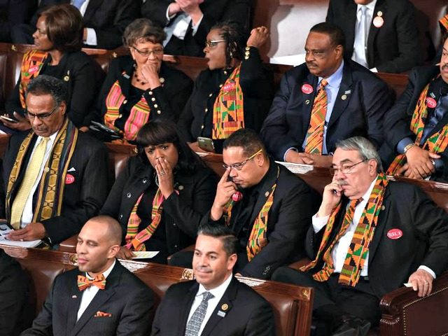 Members of Congress wear black clothing and Kente cloth in protest as US President Donald