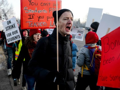Denver Public Schools teachers and members of the community picket outside South High School on February 11, 2019 in Denver, Colorado. Denver teachers are striking for the first time in 25 years after the school district and the union representing the educators failed to reach an agreement after 14 months …