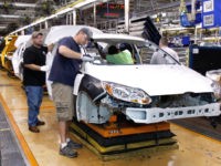 Ford Electric Car Plant Builds Electric Focus And Hybrid Vehicles Workers build a Ford Focus on the assembly line at the Ford Motor Co.'s Michigan Assembly Plant.