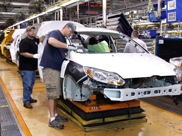 Workers build a Ford Focus on the assembly line at the Ford Motor Co.'s Michigan Assembly