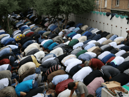 Muslims pray at The Grande Mosque in Paris on August 21, 2018, as they celebrate the first