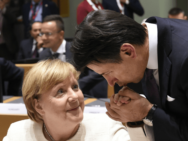 TOPSHOT - German Chancellor Angela Merkel (L) has her hand kissed by Italy's Prime Mi