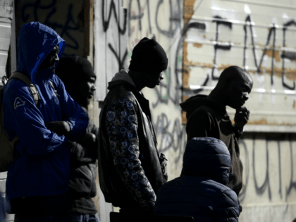 Migrants are pictured in a squatted abandoned penicillin factory on November 14, 2018 in Rome's Tiburtina district, where hundreds of migrants live in precarious conditions. - Migrants addressed the media during a press conference in the building on November 14, a day after police on November 13 bulldozed a symbolic …