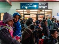 US-POLITICS-IMMIGRATION-MIGRANTS Asylum seekers stand at a bus stop after they were dropped off by Immigration and Customs Enforcement (ICE) at the Greyhound bus station in downtown El Paso, Texas late on December 23, 2018. - The group of around 200, mostly made up of Central Americans, were left without money, food …