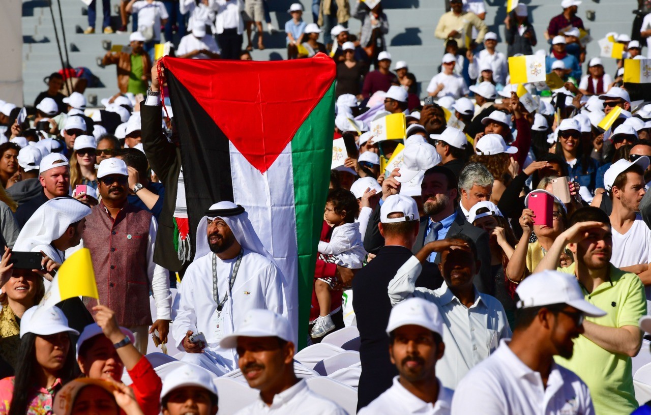A worshipper carries the Palestinian flag during mass, led by Pope Francis, for an estimated 170,000 Catholics at the Zayed Sports City Stadium on February 5, 2019. (Photo by Giuseppe CACACE / AFP) (Photo credit should read GIUSEPPE CACACE/AFP/Getty Images)