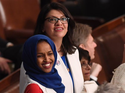 US Representative Ilhan Omar (D-MN) (L) and US Representative from Michigan Rashida Tlaib (D-MI), dressed in white in tribute to the women's suffrage movement, arrive for the State of the Union address at the US Capitol in Washington, DC, on February 5, 2019. (Photo by SAUL LOEB / AFP) (Photo …